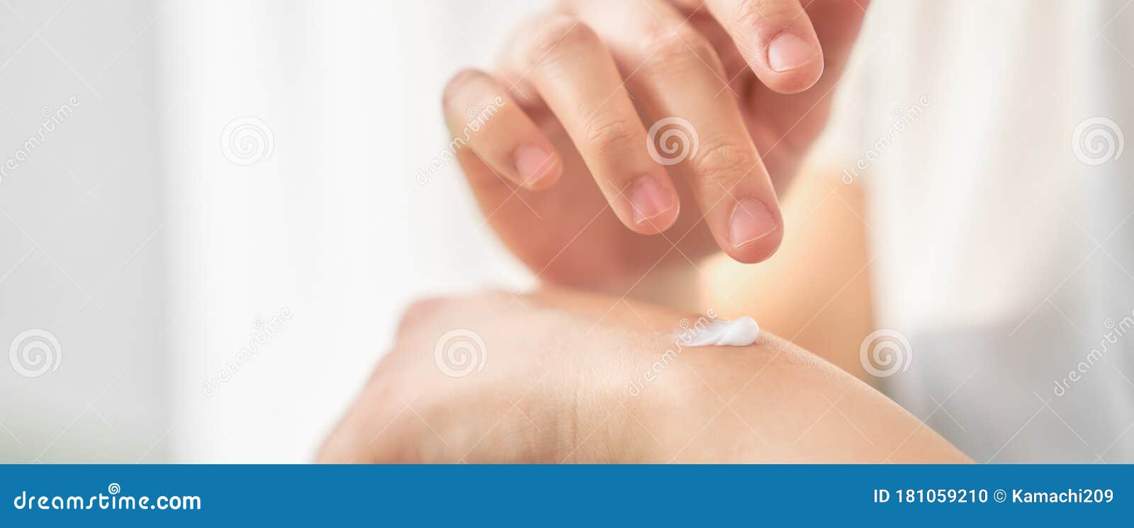 close up of woman hand holding and applying moisturiser, body lotion,  on white background.