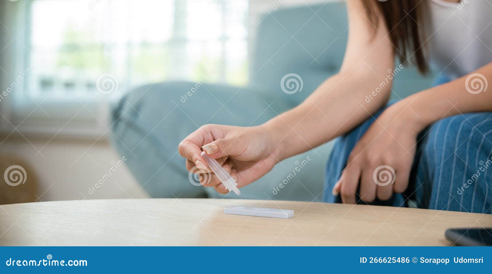 close up woman hands using rapid antigen test kit for selftest