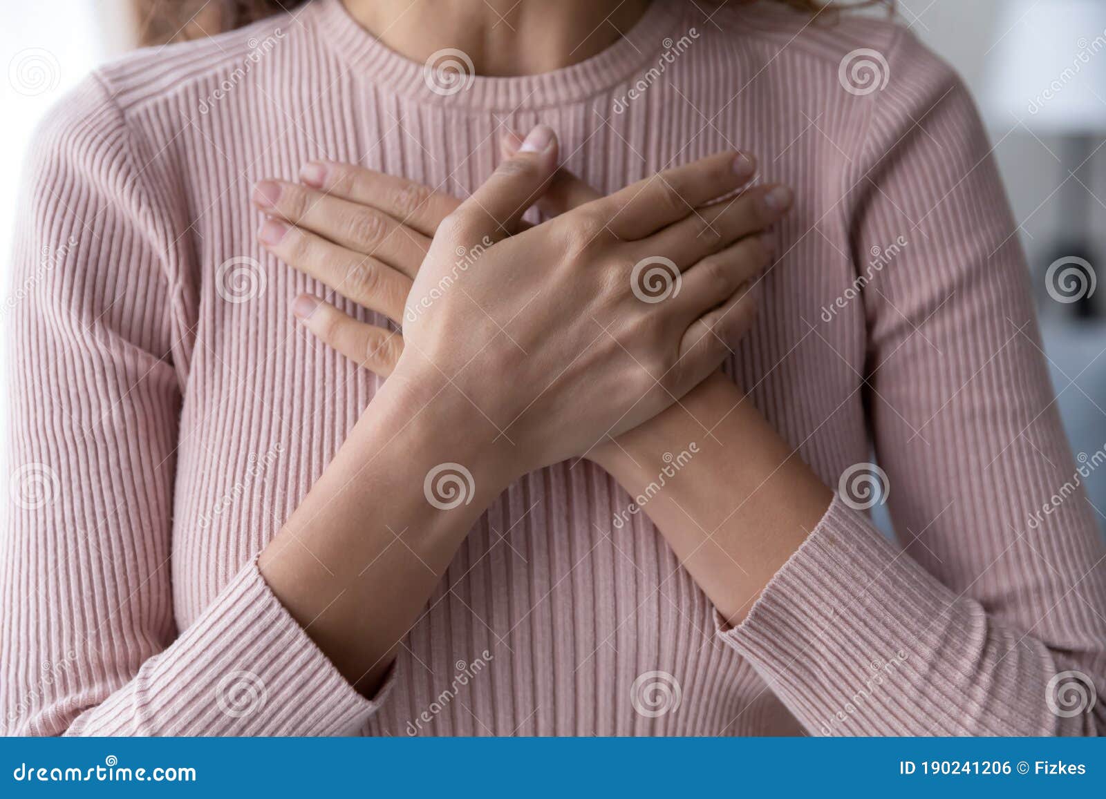 close up of woman keep hands at chest show gratitude