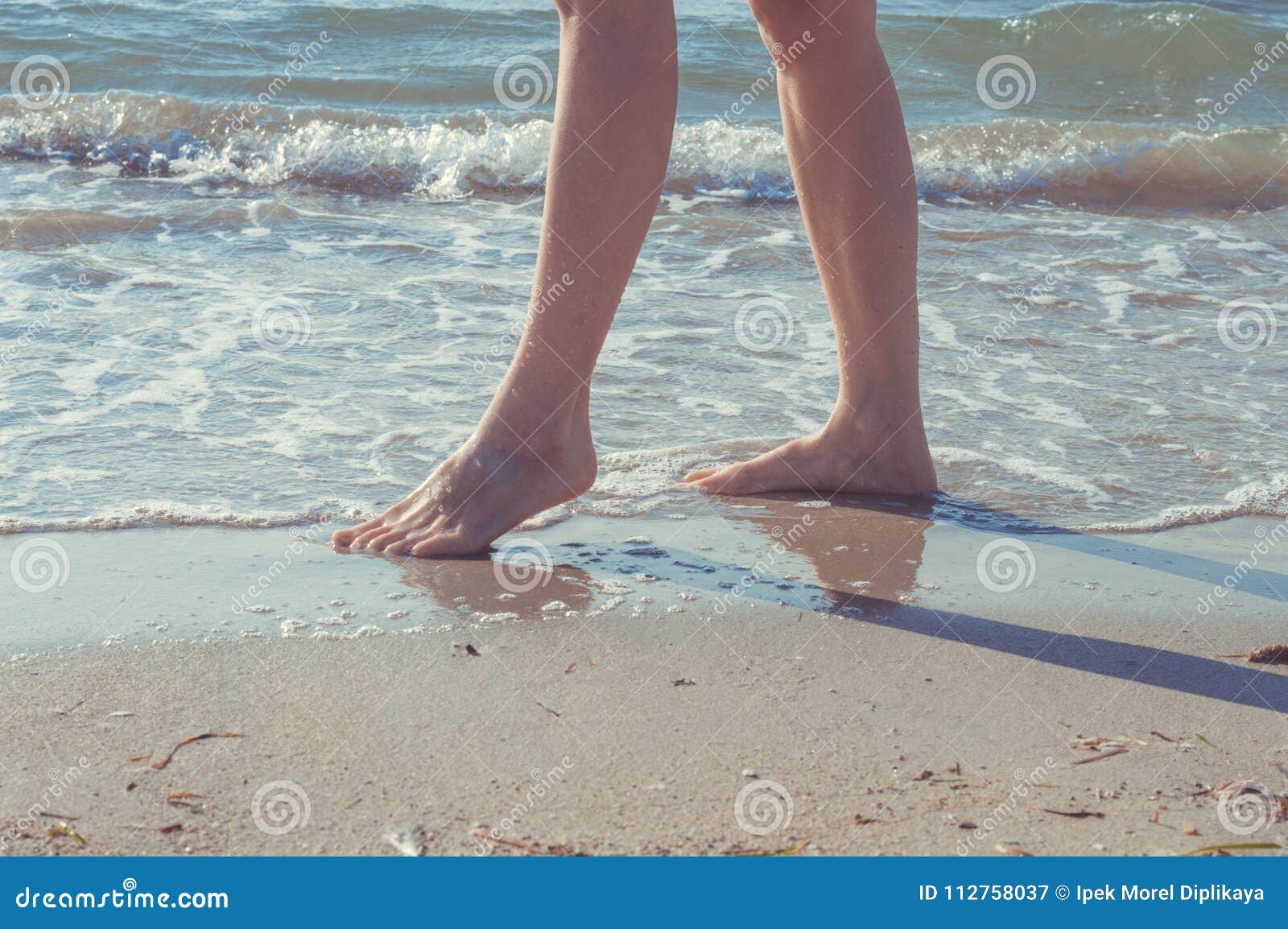 Young Woman Walking Barefoot On The Beach Stock Image 