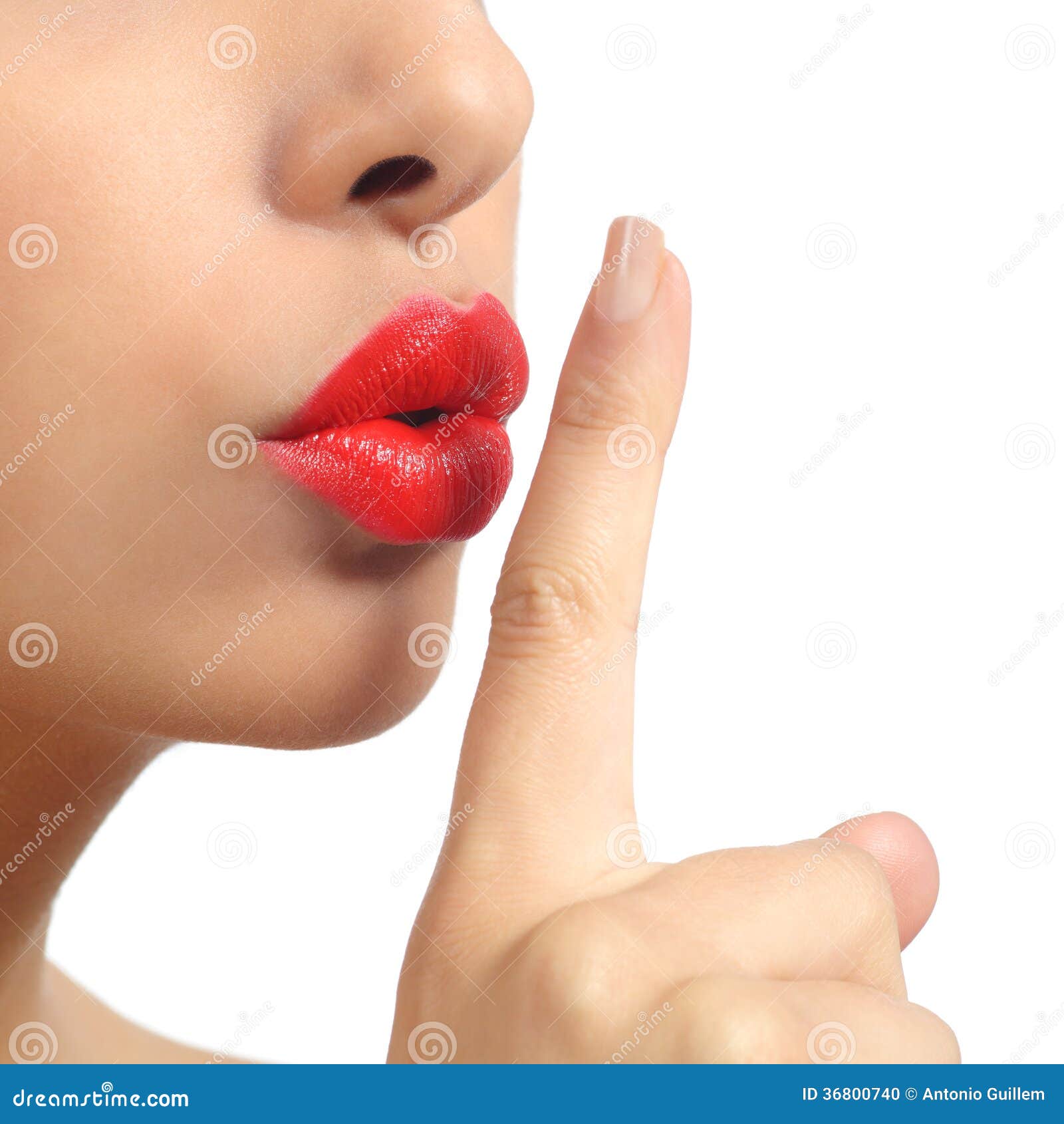 close up of a woman lips with finger asking for silence