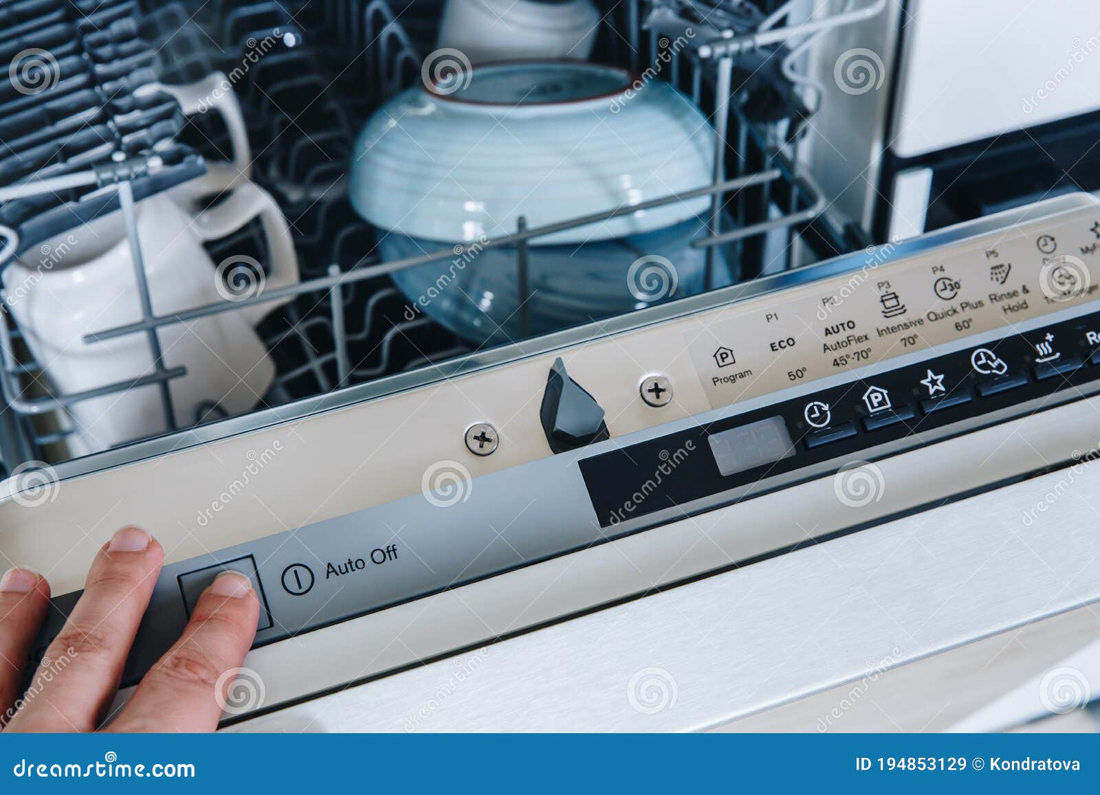 Closeup of Woman`s Finger Pressing Start Button on Dishwasher in the