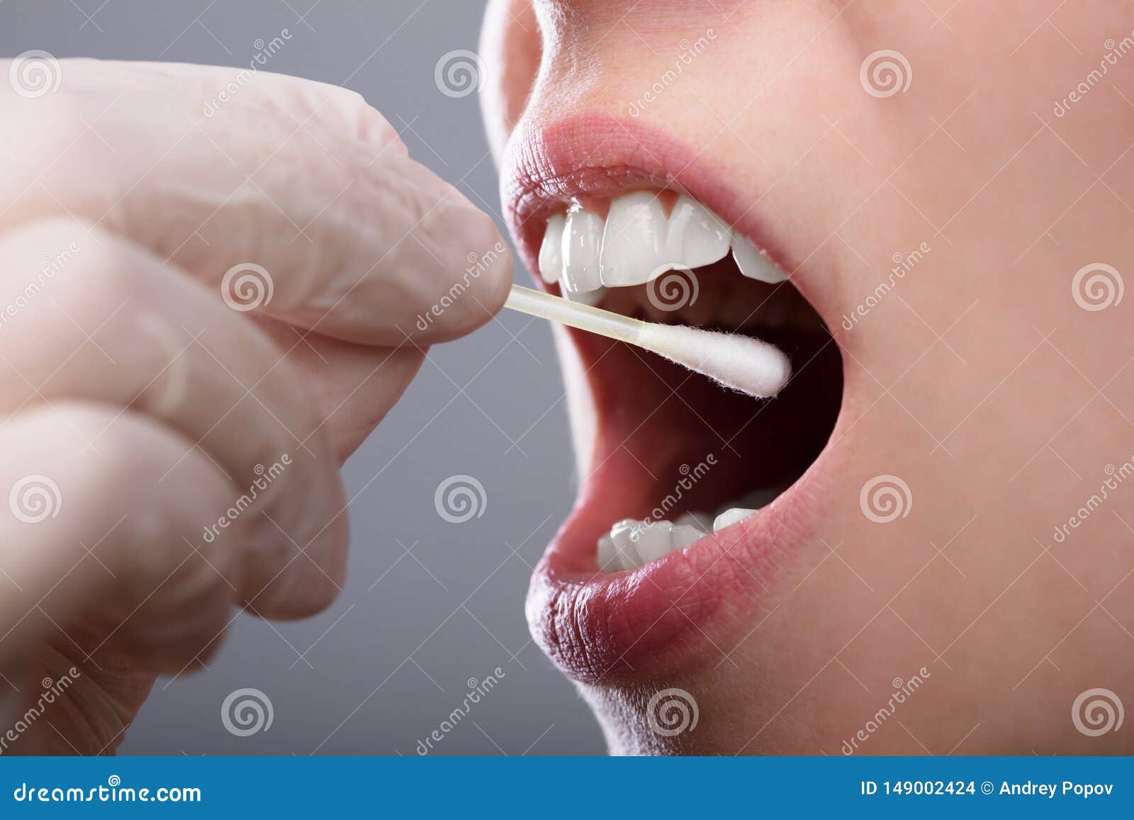 woman taking saliva test from her mouth