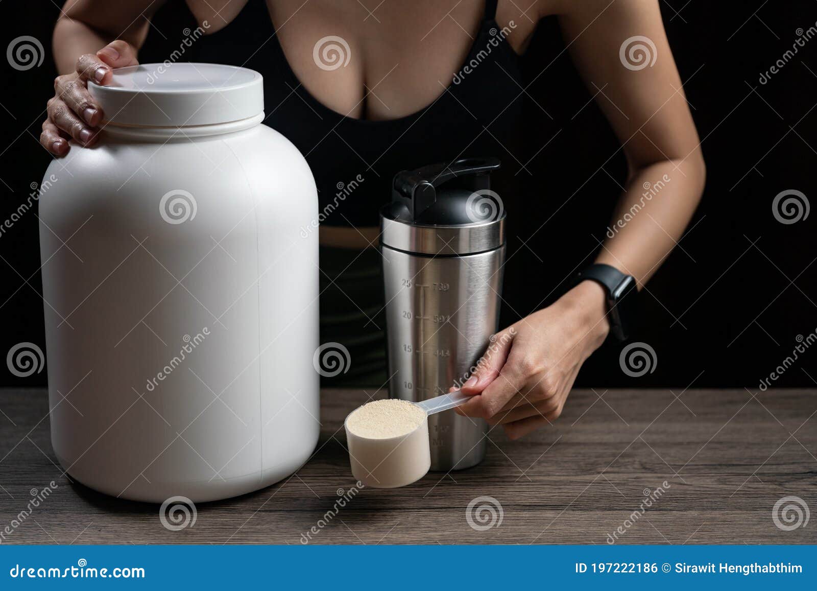 Close Up of Women with Measuring Scoop of Whey Protein, Jar and