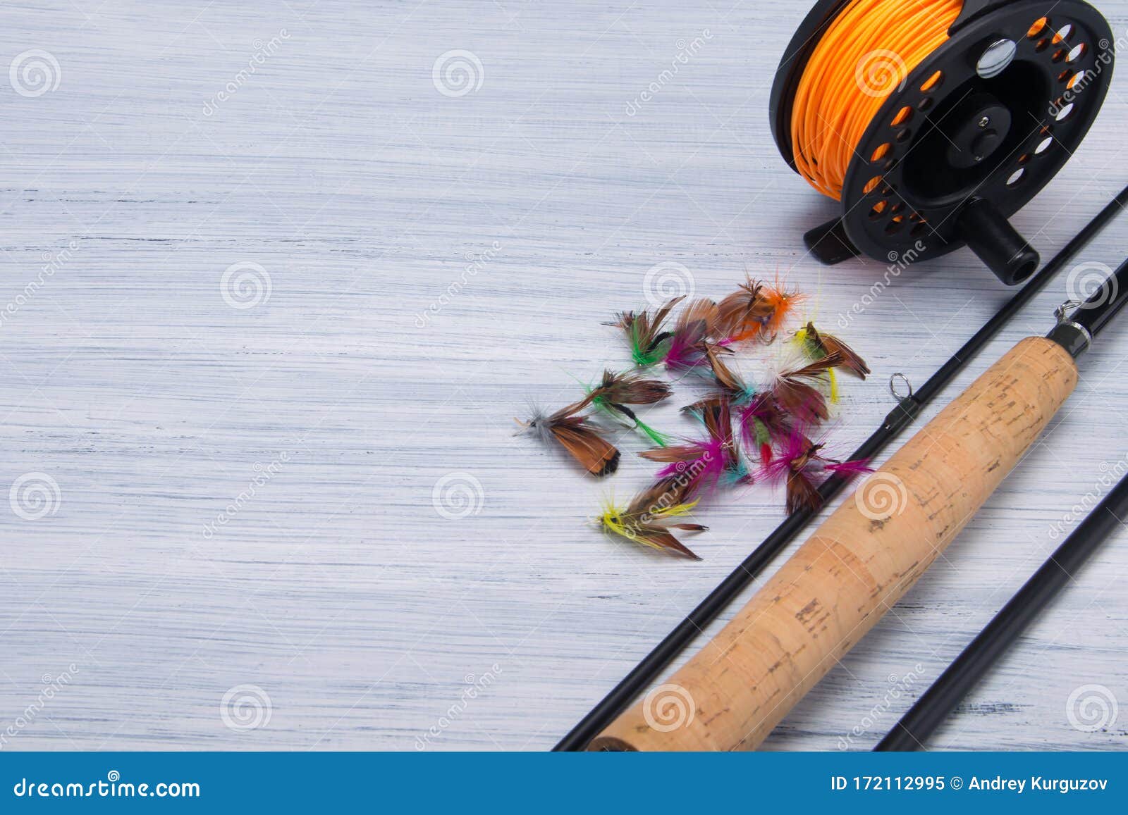 Close-up of a Wooden Handle from a Fishing Rod, a Reel with a Fishing Line  and a Bait with a Hook, for Catching Fish, on a Light Stock Image - Image of