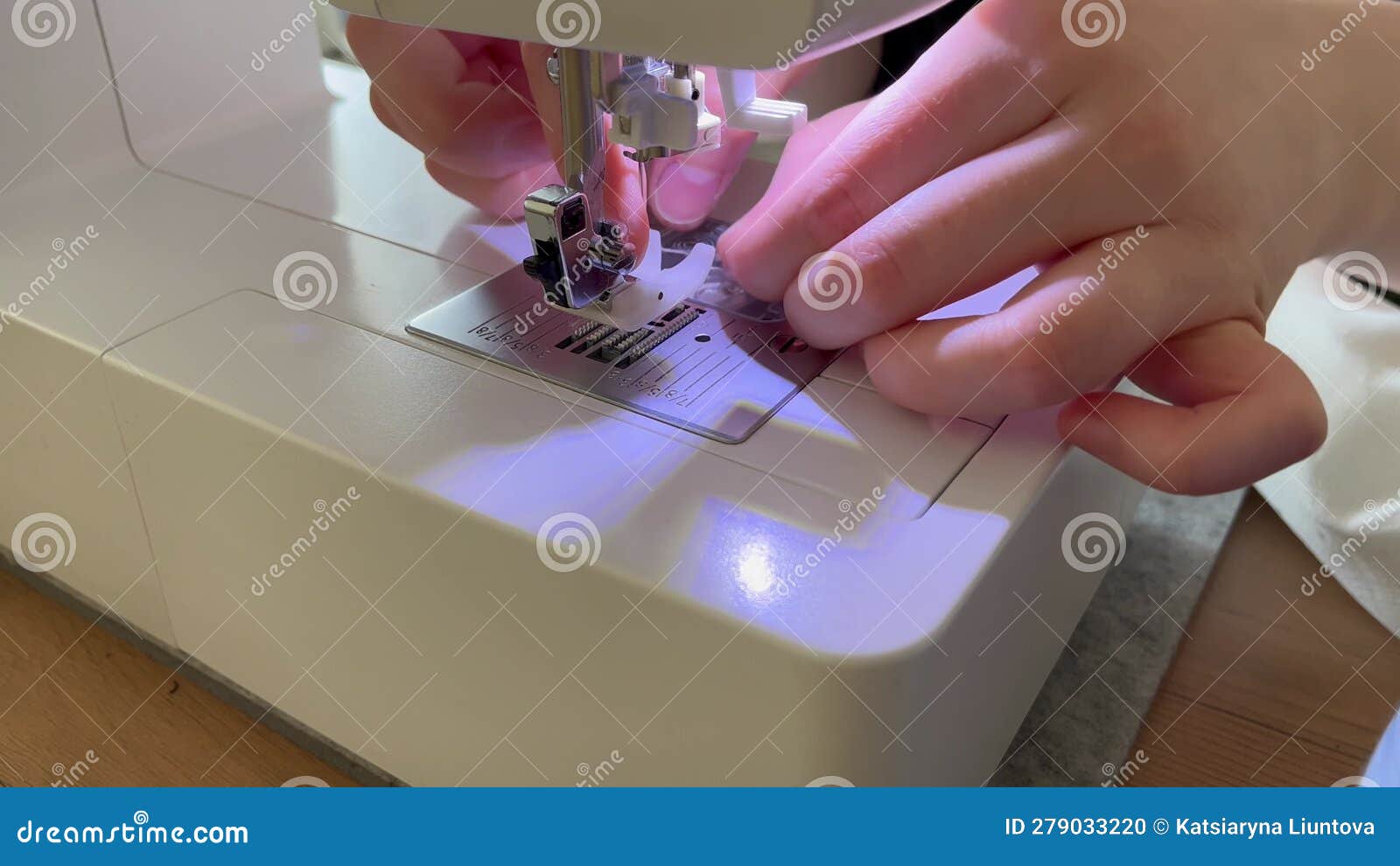 Closeup of the Work of a Sewing Machine. Hands Inserting a Thread into