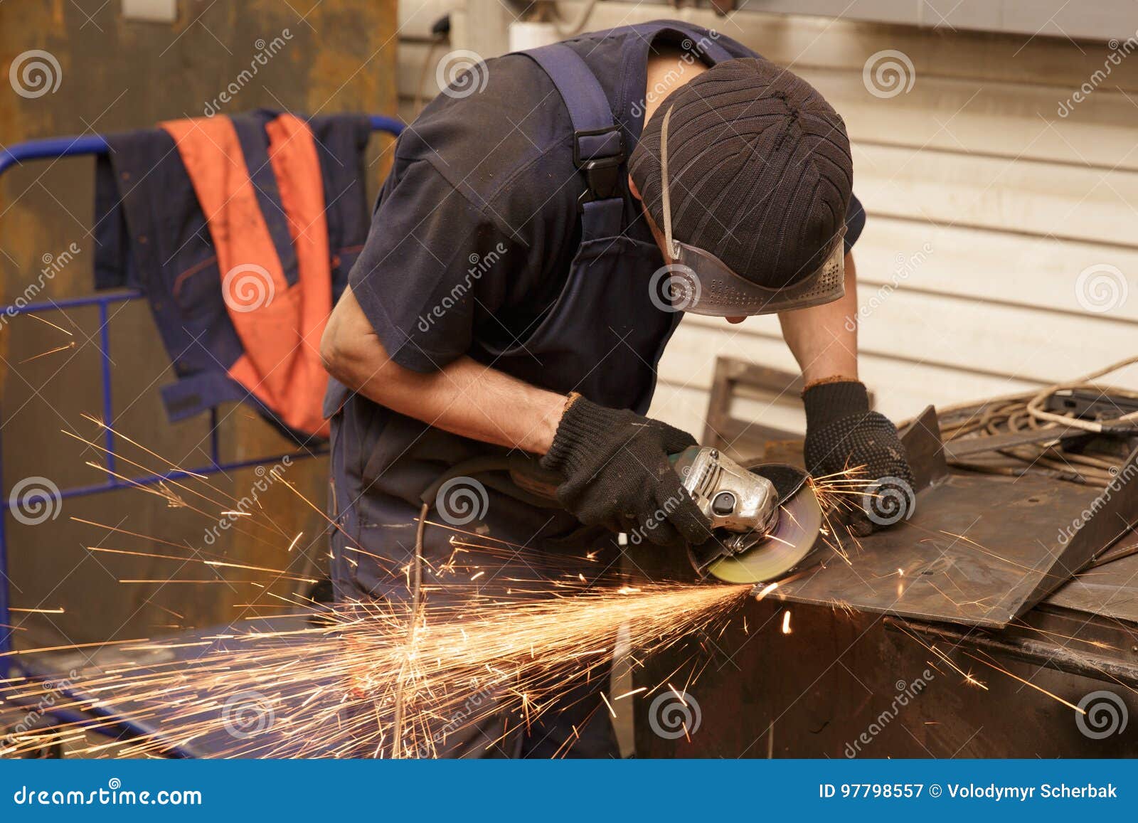 Closeup of Worker Cutting Metal with Grinder. Sparks while Grinding