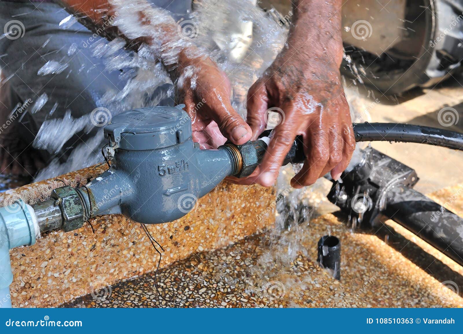 close-up of worker hands plumbing unscrew connecting pipe while