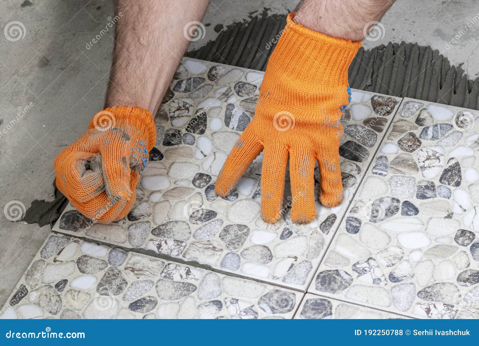 Close Up of a Worker`s Hand Leveling a Ceramic Tile. Process of Laying