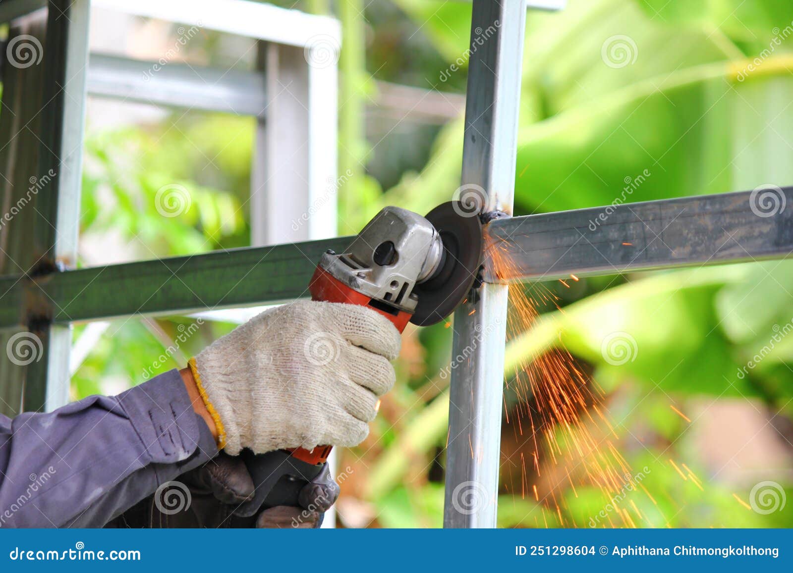Close Up Worker Using Angle Grinder Polishing Steel Structure with