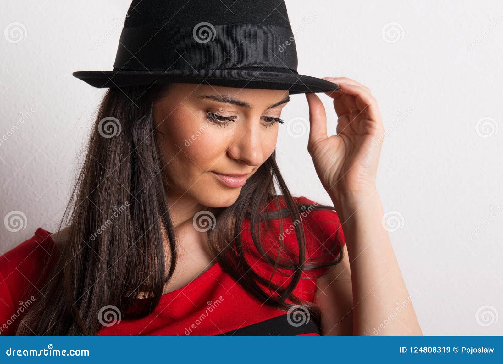 A Close-up of a Young Beautiful Woman with Black Hat in a Studio. Stock ...