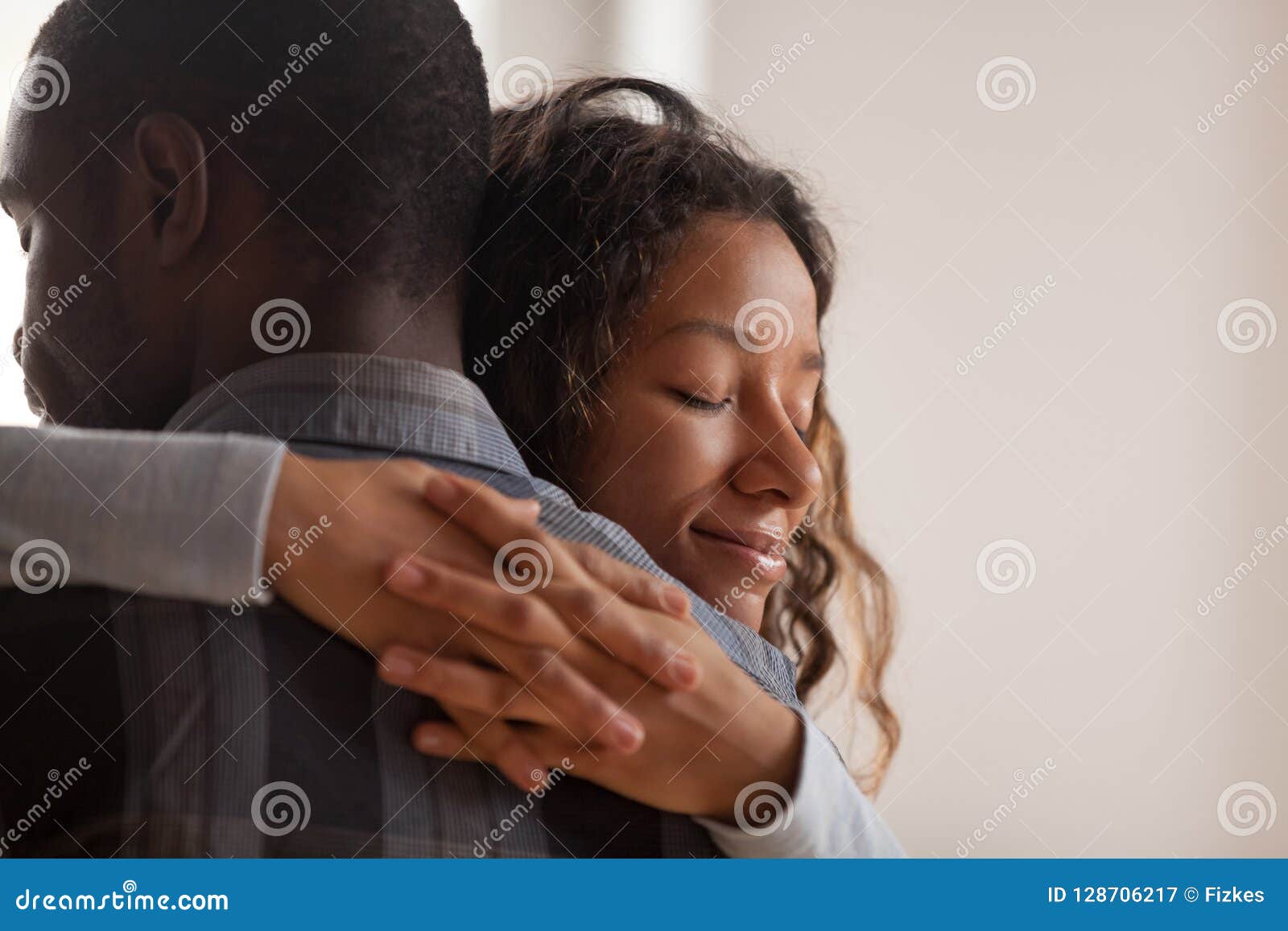 close up black african wife embracing husband