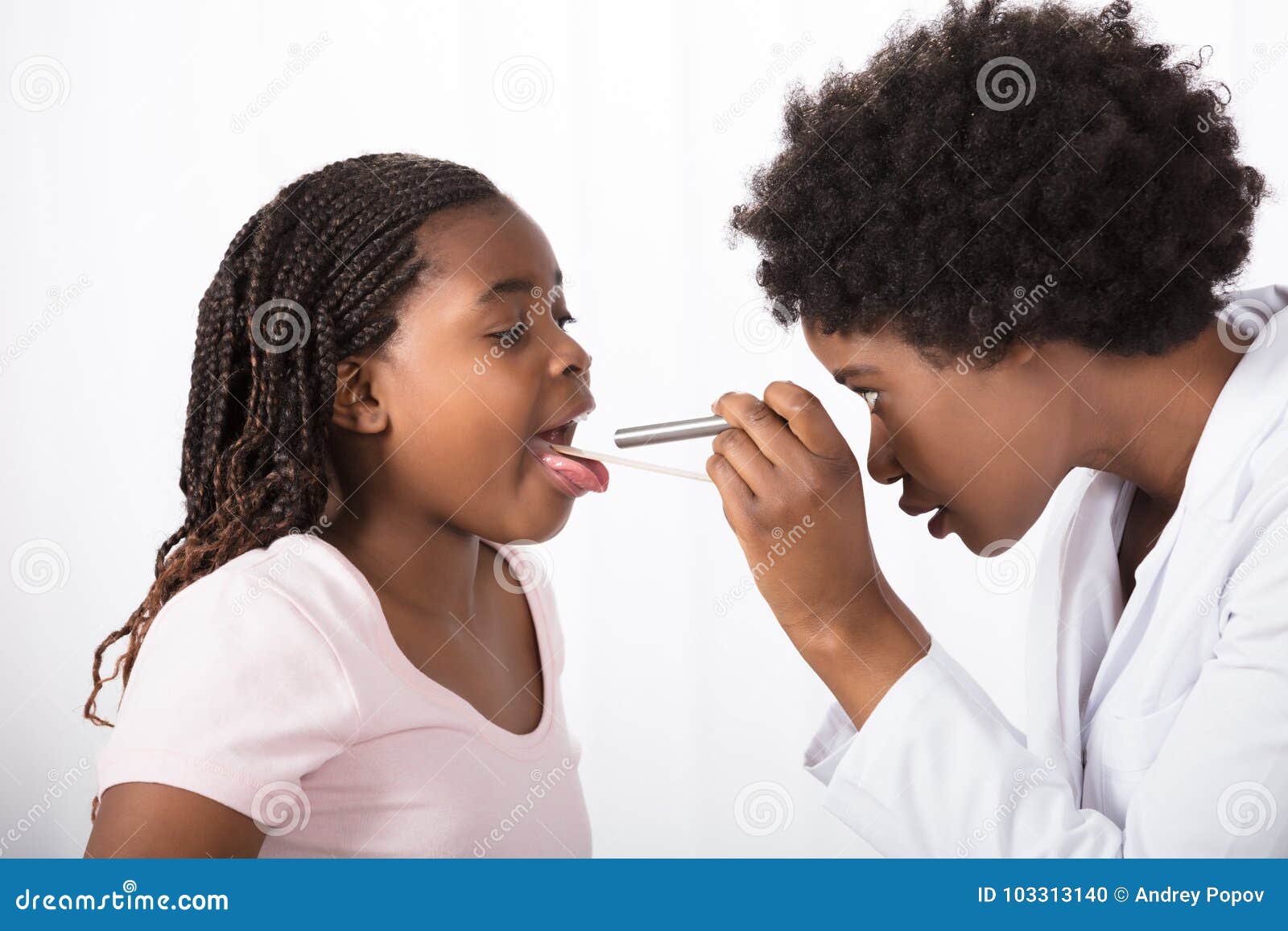 doctor checking his patient`s throat