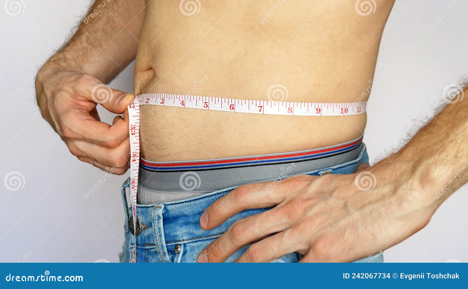 https://thumbs.dreamstime.com/z/close-up-young-man-blue-jeans-measures-waist-against-white-background-young-man-blue-jeans-measures-his-waist-242067734.jpg