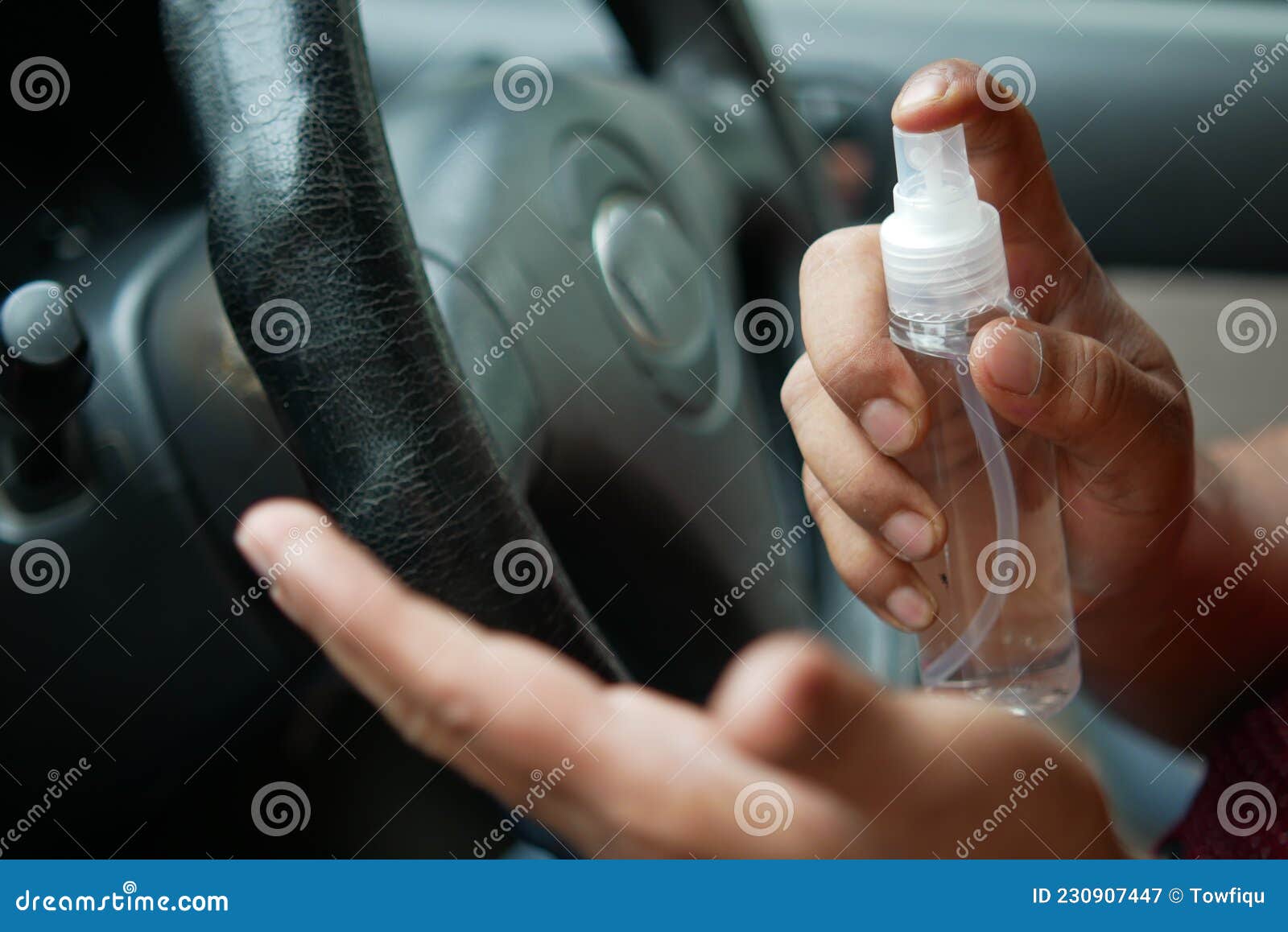 Close Up of Young Man Hand Using Hand Sanitizer Spray in a Car Stock
