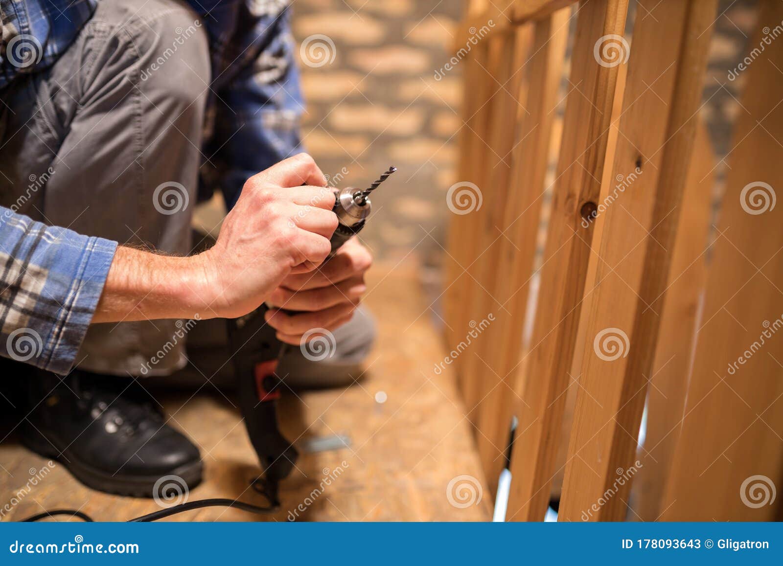 close-up of a young man replacing drill bits and tightening drill head