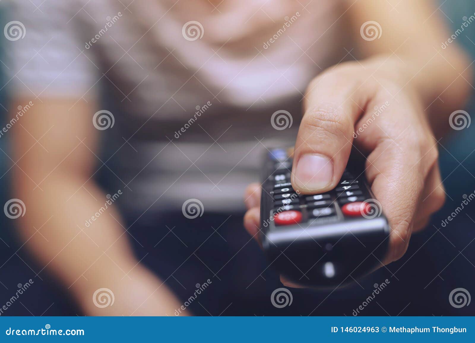 close up young man is using television remote contro