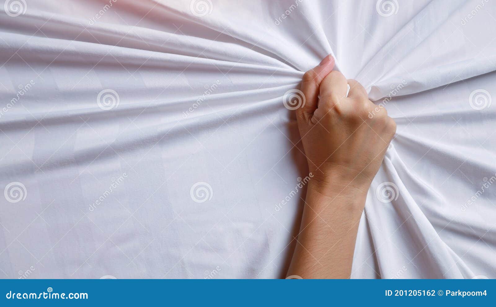 Close Up Young Woman Hands Pulling White Sheets in Ecstasy in Hotel picture pic
