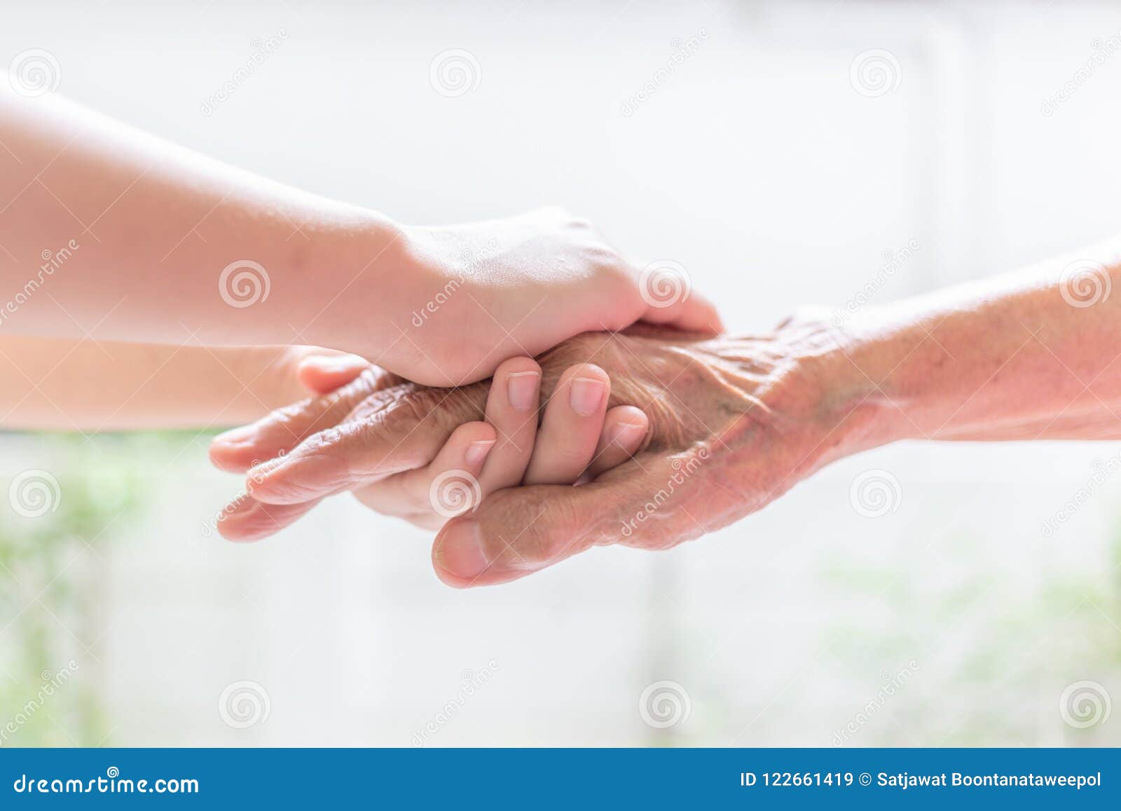 close up of young woman hand holding with tenderness an elderly
