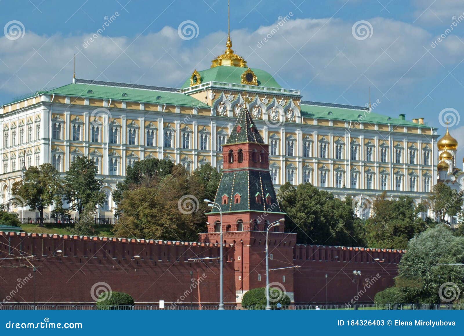 close view of kremlin wall with tower and cathedral photo made from opposite bank of the river moscow