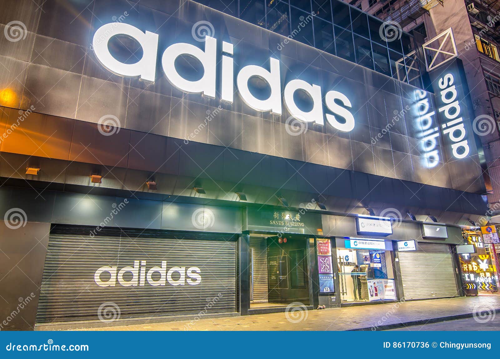 A Closed Adidas` Shop At Night Outside 
