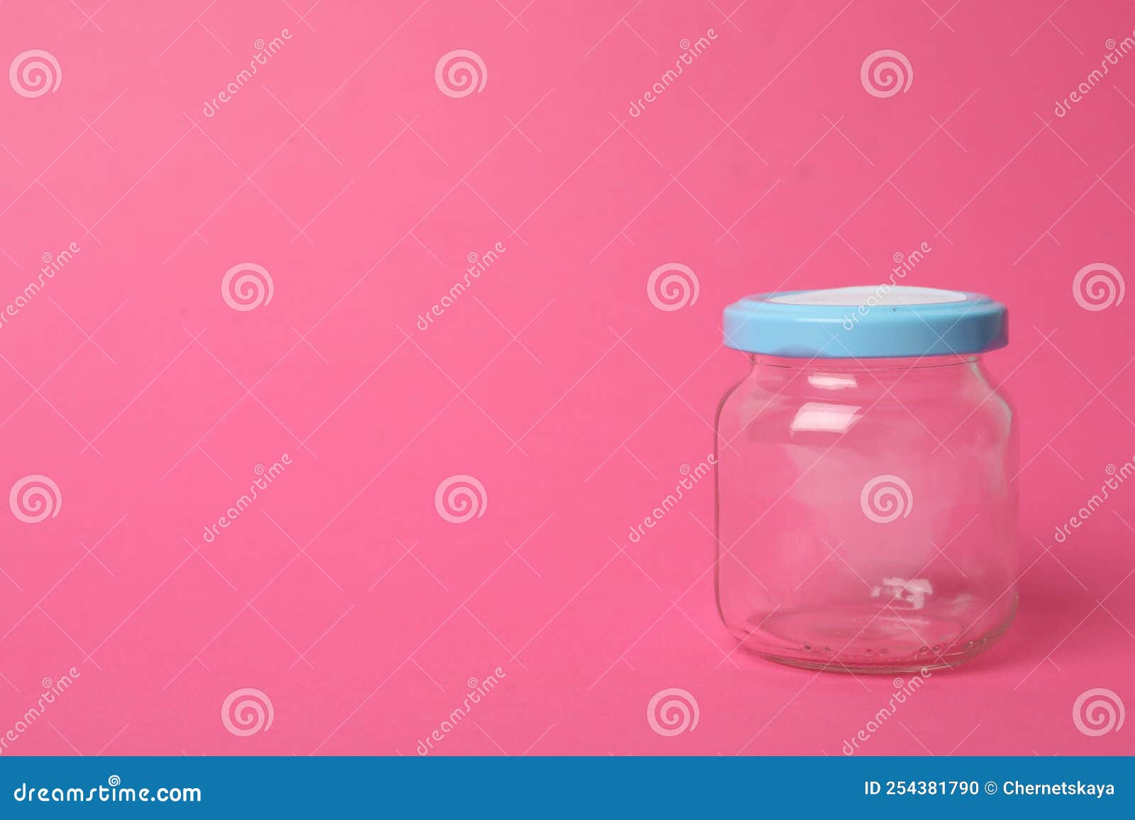 Closed Empty Glass Jar on Pink Background, Space for Text Stock Photo
