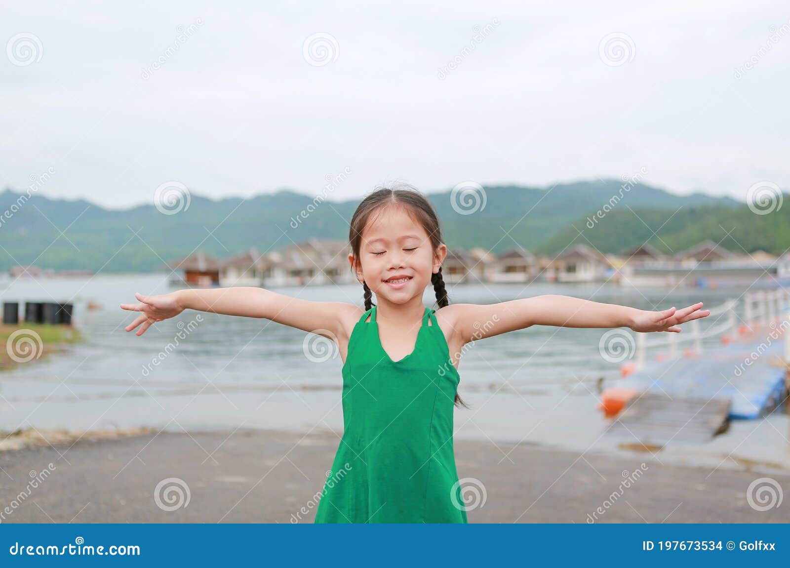 Closed Eyes Little Asian Kid Girl Stretch Arms and Relaxes in Hillside ...