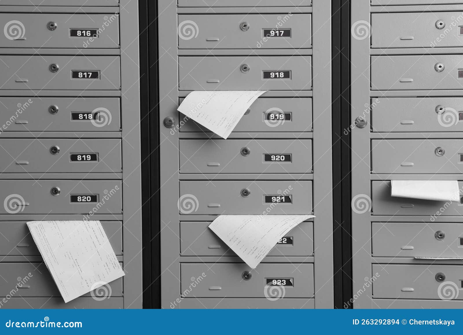 Closed Grey Metal Mailboxes with Receipts Indoors Stock Photo Image