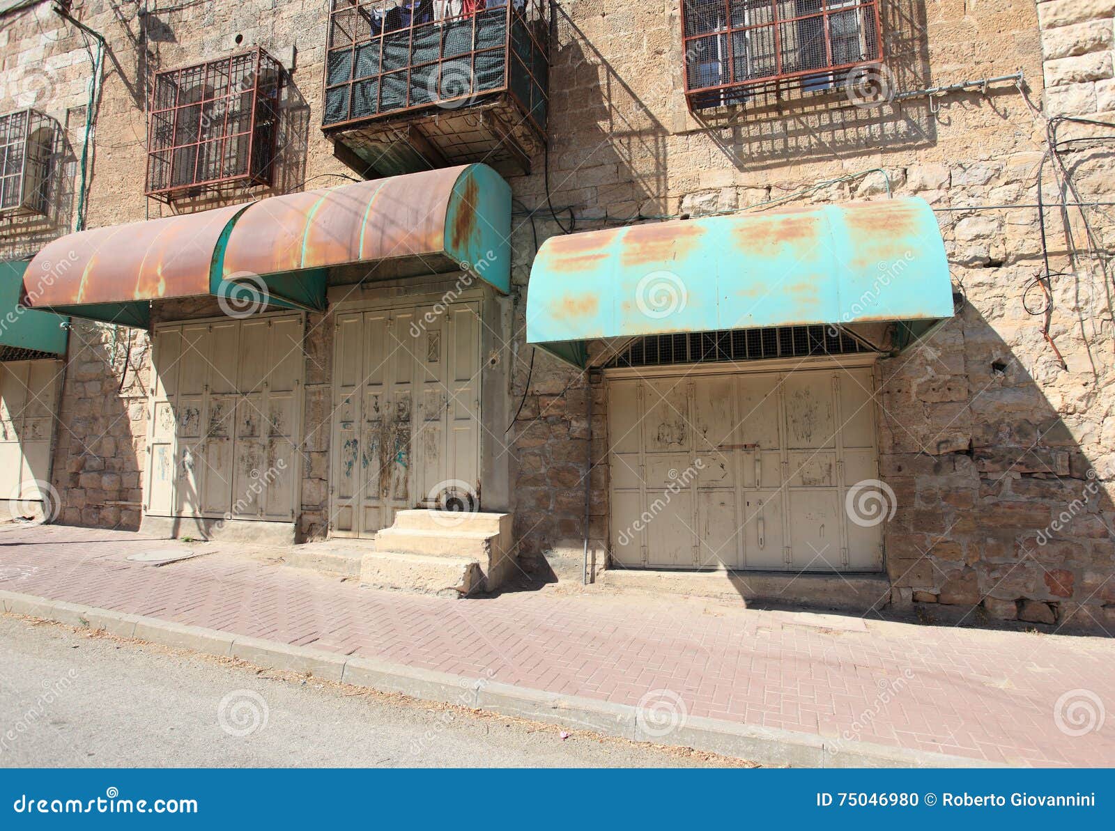 closed shops, houses with grating, hebron