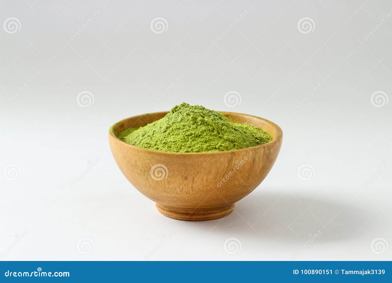 closed up isolate heap of extract green tea powder in wooden bo