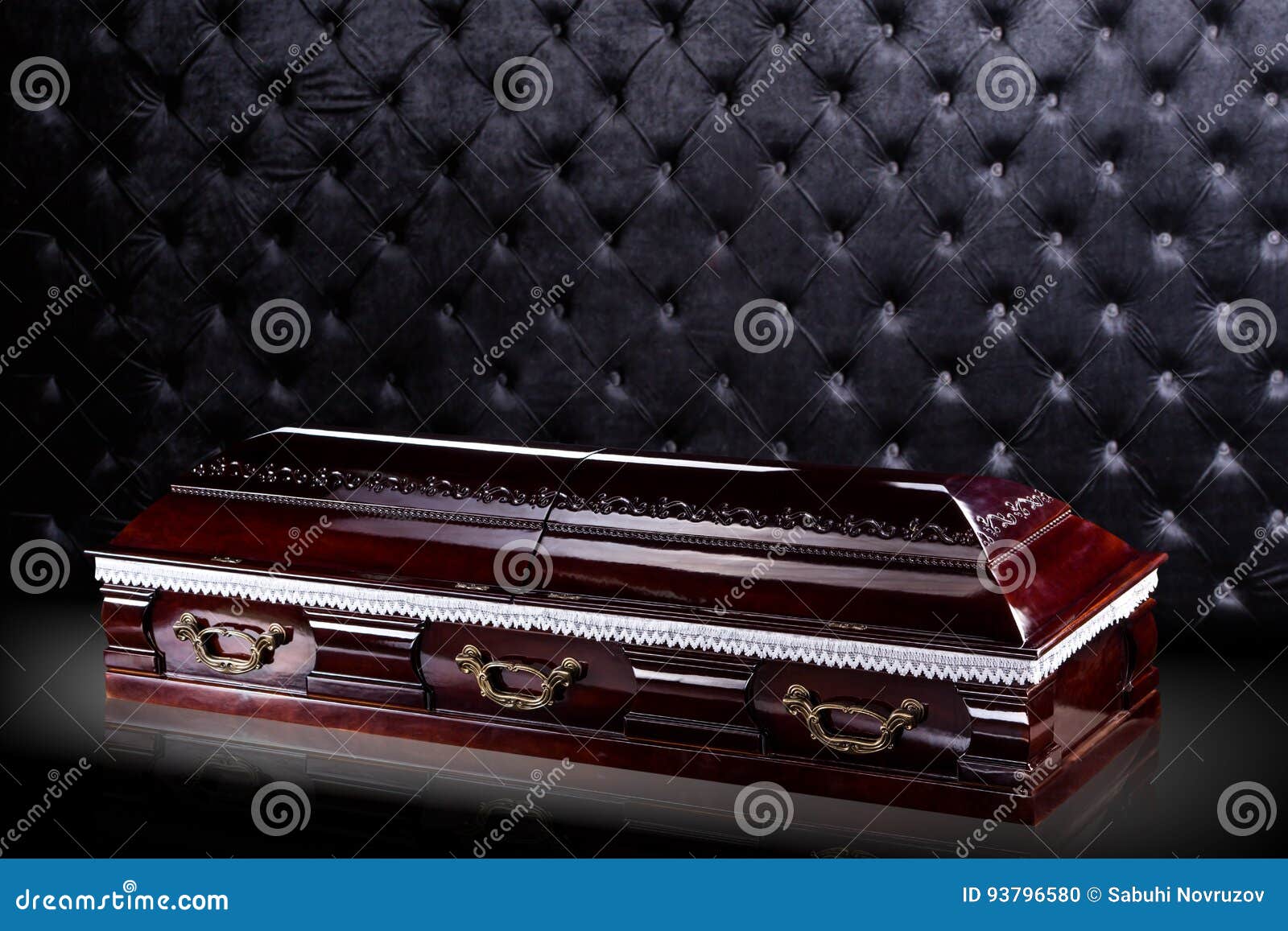 closed wooden dark brown coffin on gray luxury background. casket, sarcophagus on royal background.