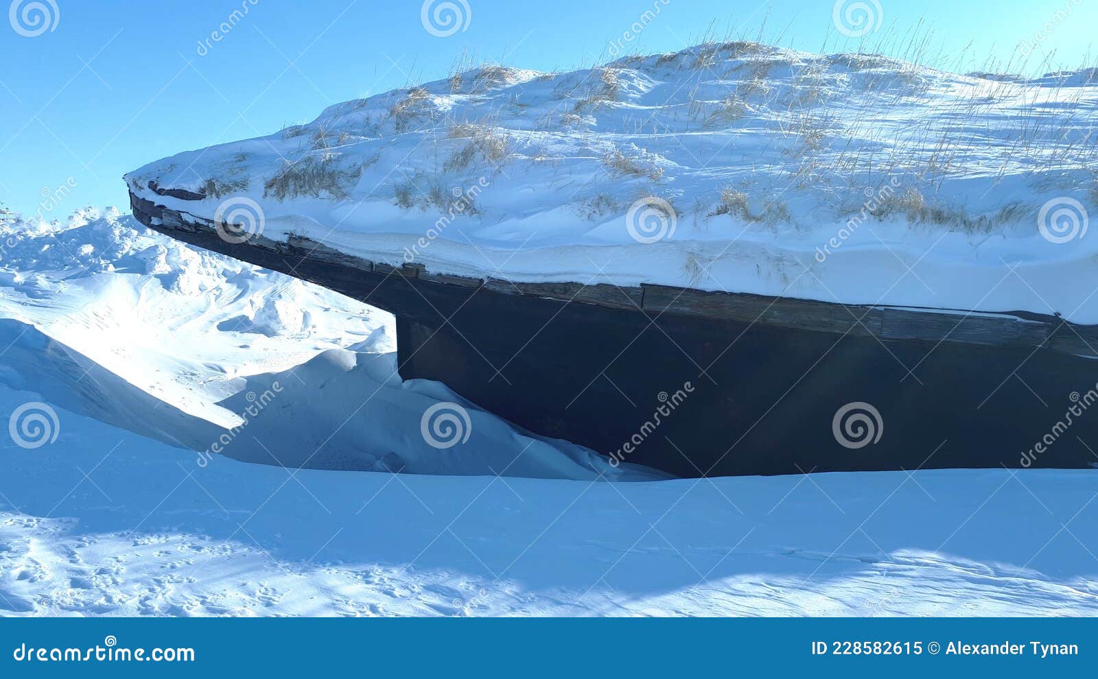 closen of a frozen rusty ship full of snow. frozen and abandoned ship in the arctic