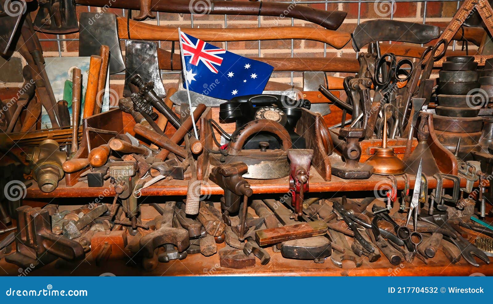 Closeup of an Assortment of Old Tools and Axes on a Workbench, with the