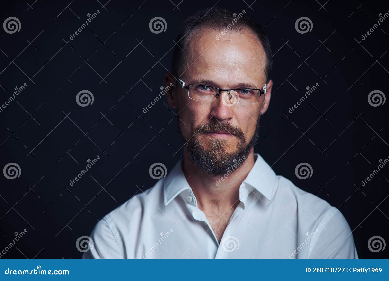 concentraited middle age man in white shirt and eyeglasses looking squinting at camera