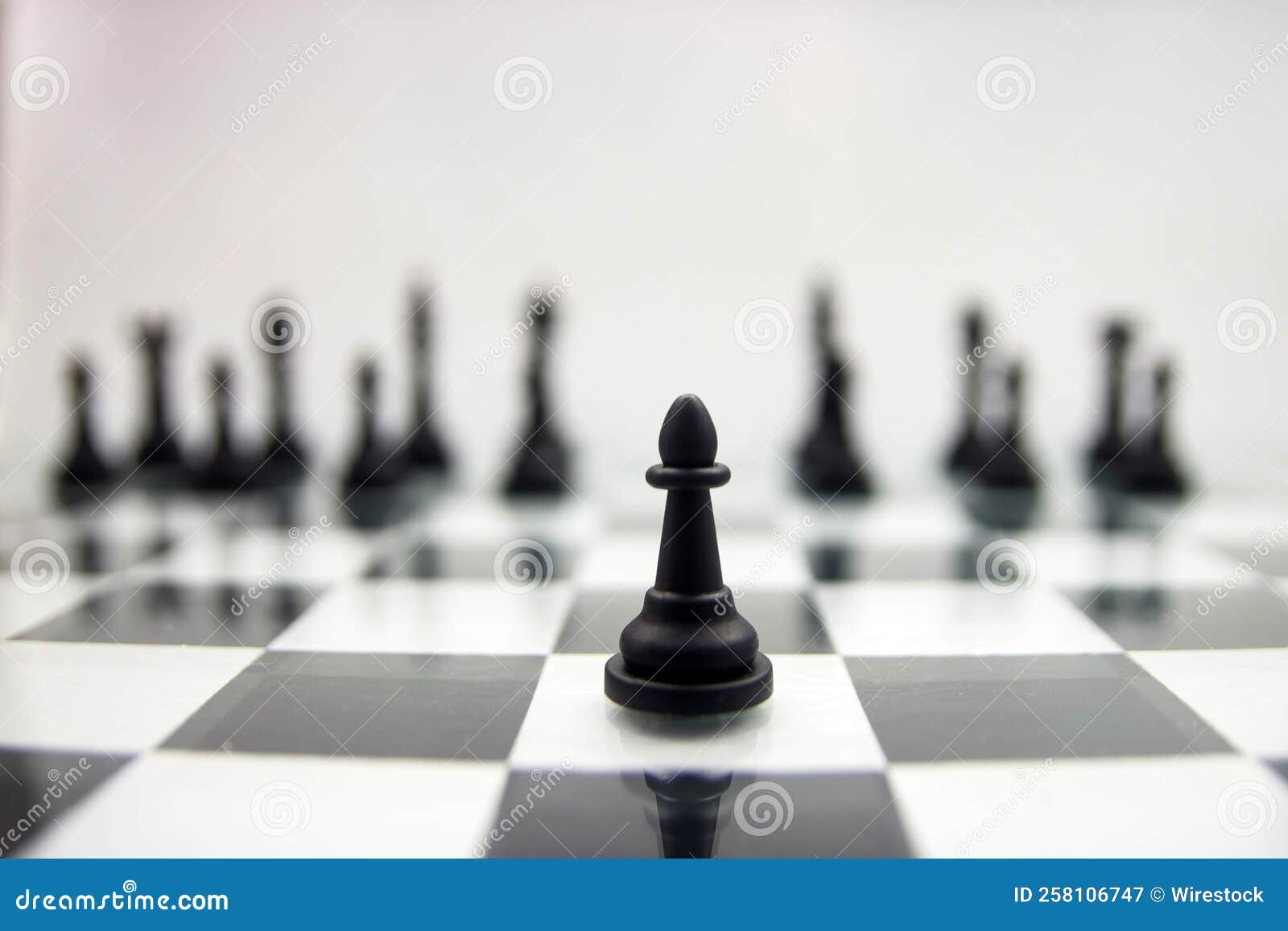 Closeup of a Black Pawn on a Glossy Chessboard on the Blurry Background ...