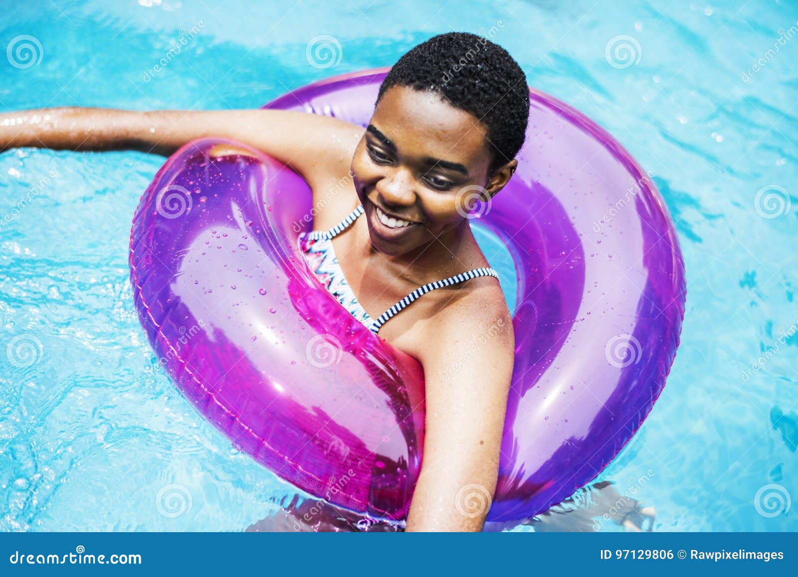 Closeup of Black Woman Floating with Tube in the Pool Stock Photo