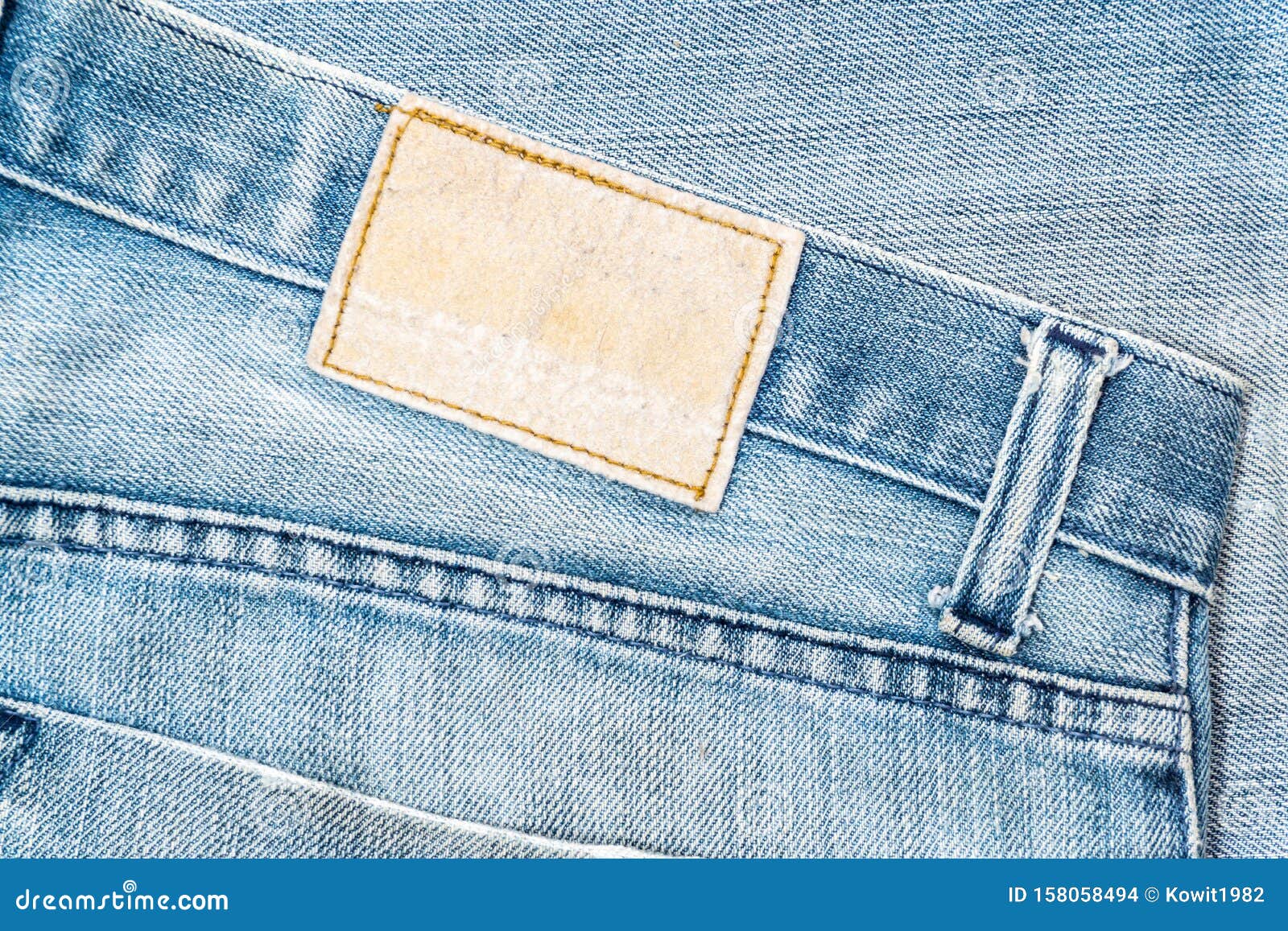 Closeup of Blank Grungy Leather Label on Worn Blue Denim with Orange ...