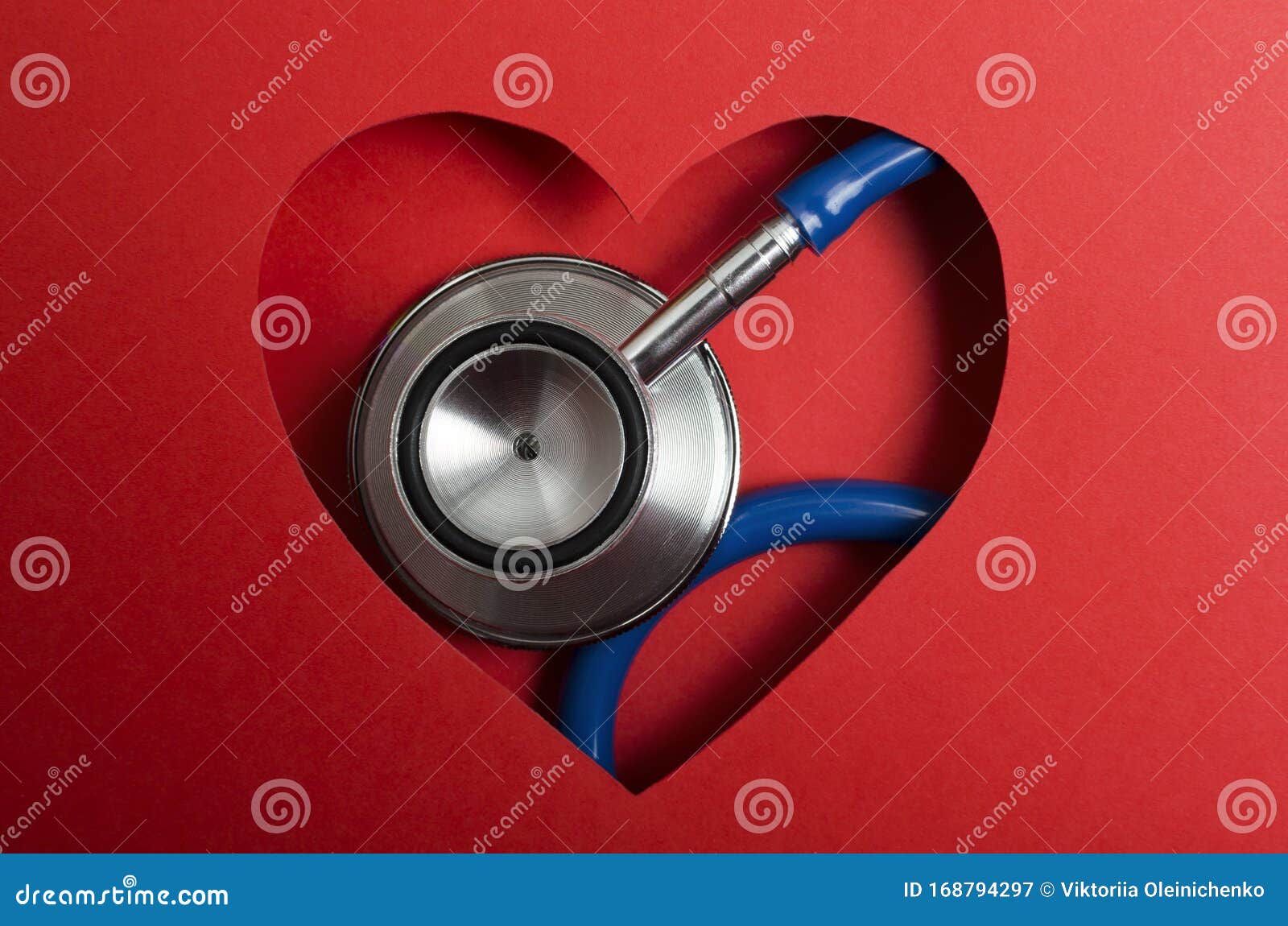 closeup of blue medical stethoscope and red paper heart . concept of cardiac health