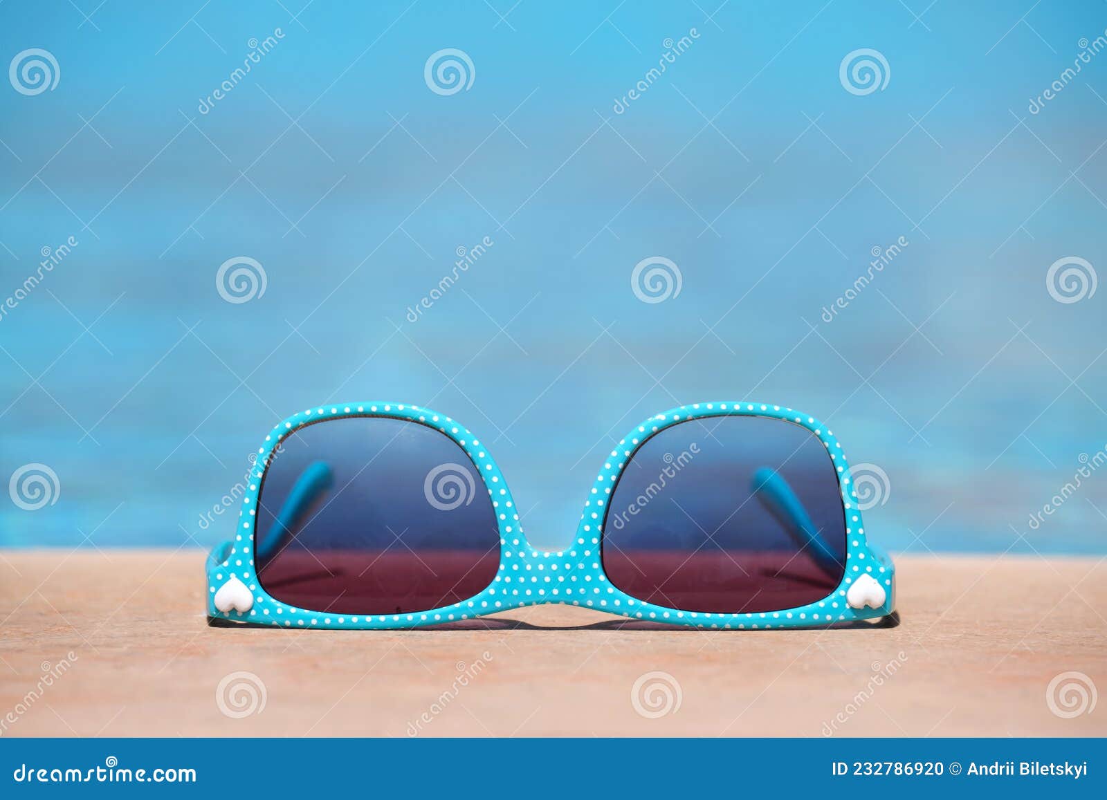 Closeup of Blue Sunglasses on Swimming Pool Side on Warm Sunny Day ...