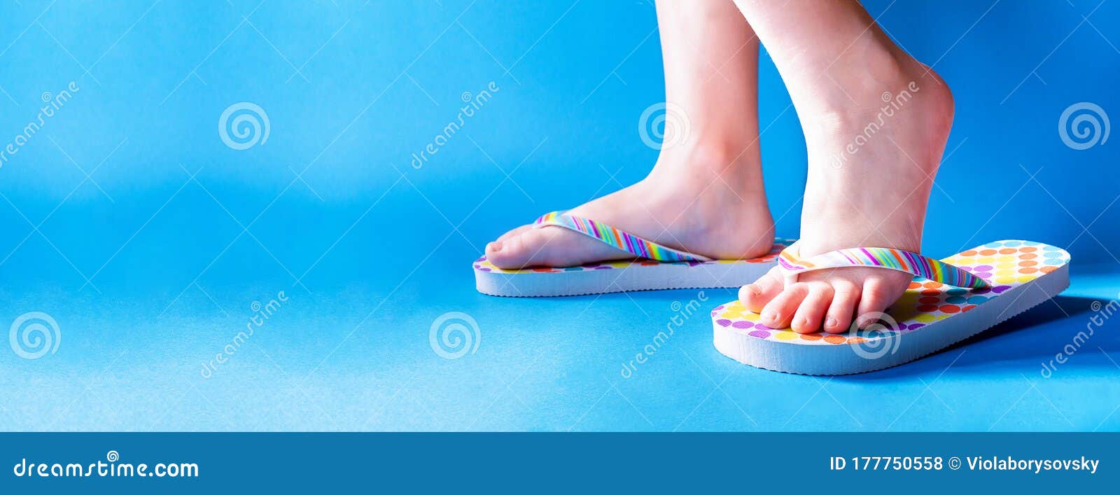 Closeup Child Feet Wearing a Pair of Fun Bright Flip-flops on Blue ...