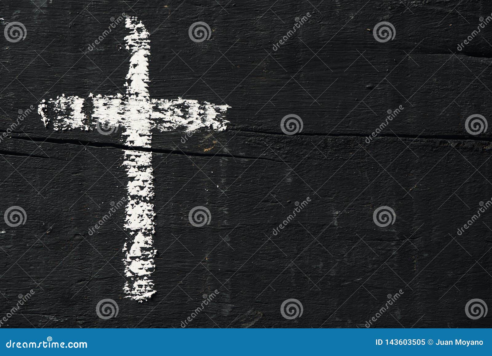 christian cross on a dark gray wooden surface