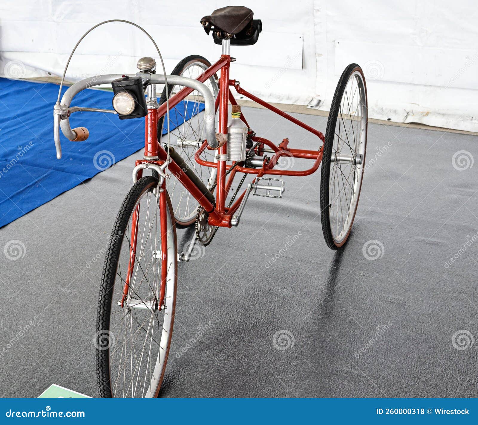 Closeup of a Classic Red Retro Bike with Two Wheels on the Back Stock