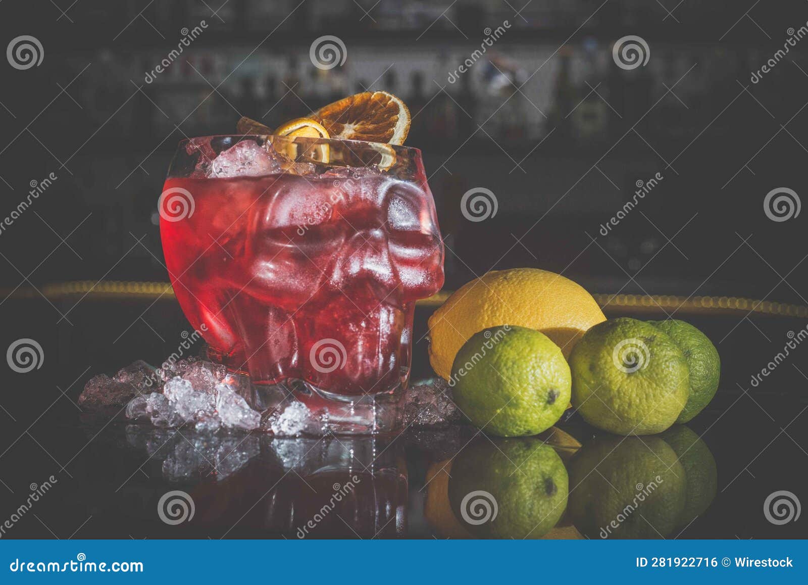 closeup of cocktail bloody mary in a skull-d glass with garnish on the table