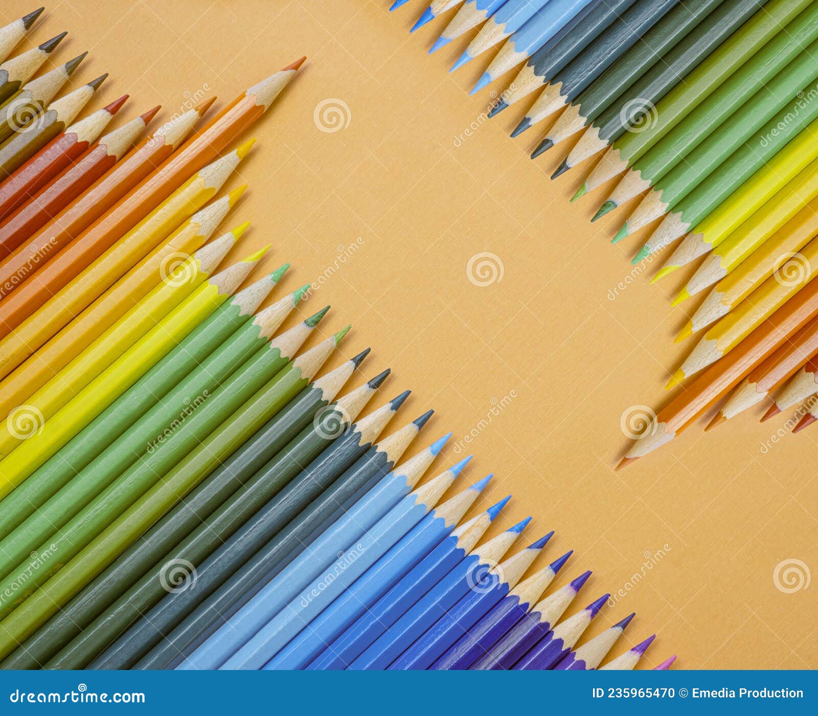 Closeup of Colored Pencils Lined Up in a Row and Abstract Shape on