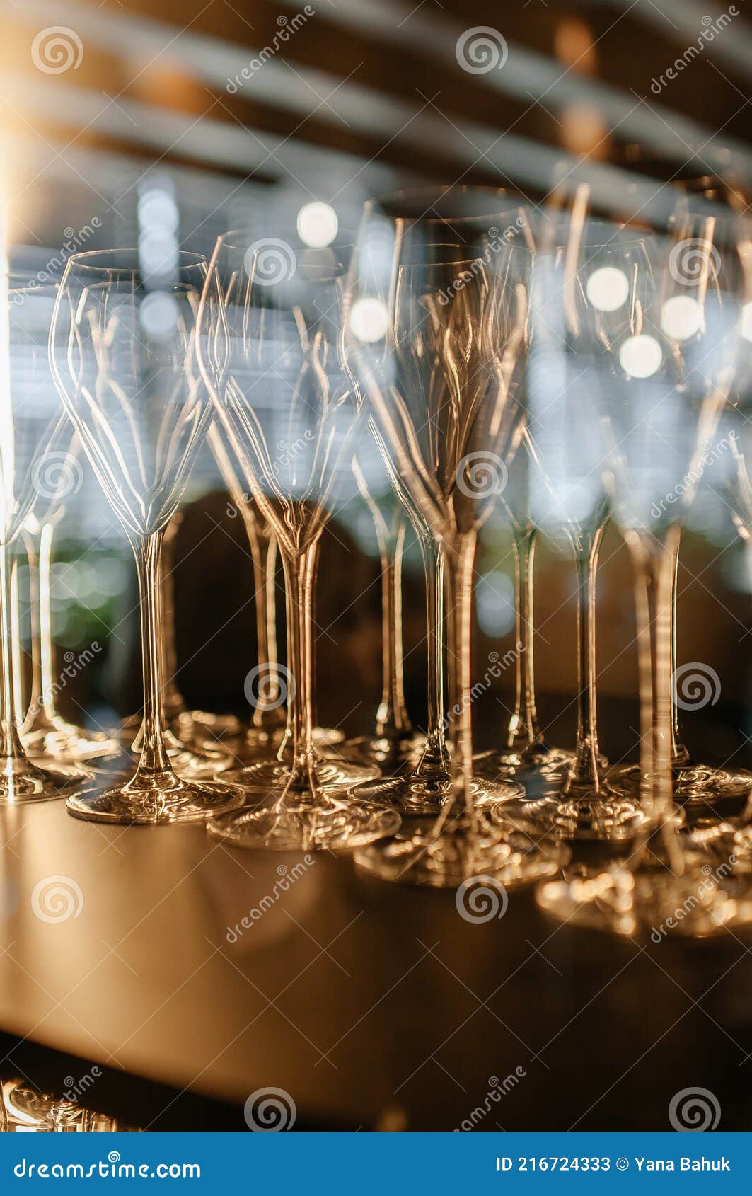 closeup of colorful wine glasses.wine glasses on a glass shelf with lighting. empty crystal glasses close-up
