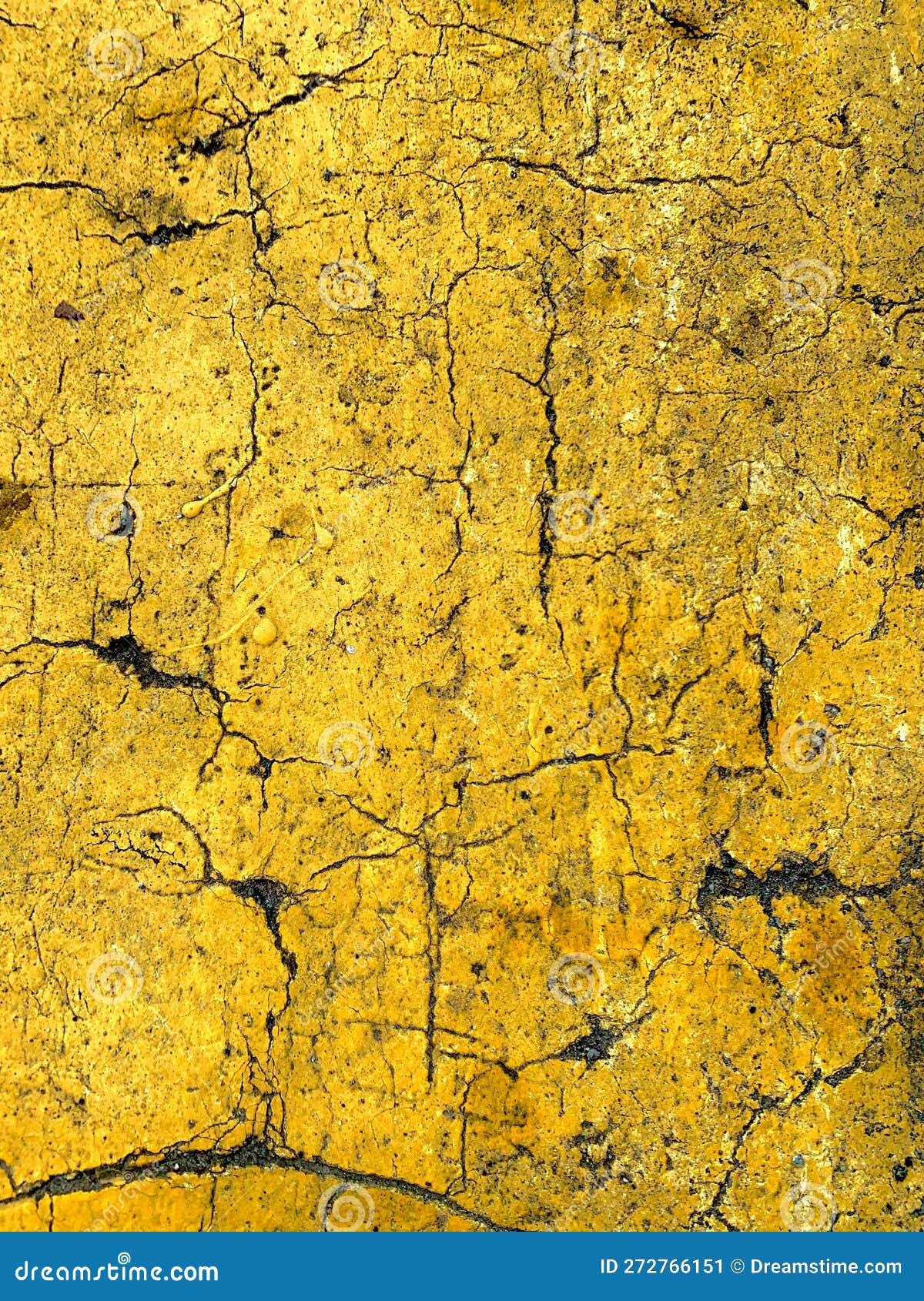 Closeup of a Cracked Concrete Wall with Yellow Paint Smeared Across Its