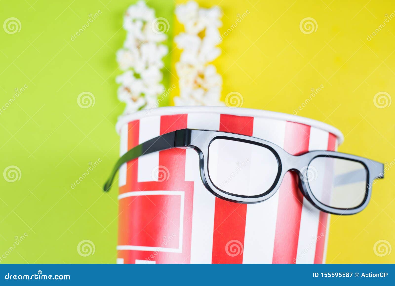 closeup cropped view photo of paper box with tasty popcorn wearing black cool with reflection specs behaving like a human enjoying