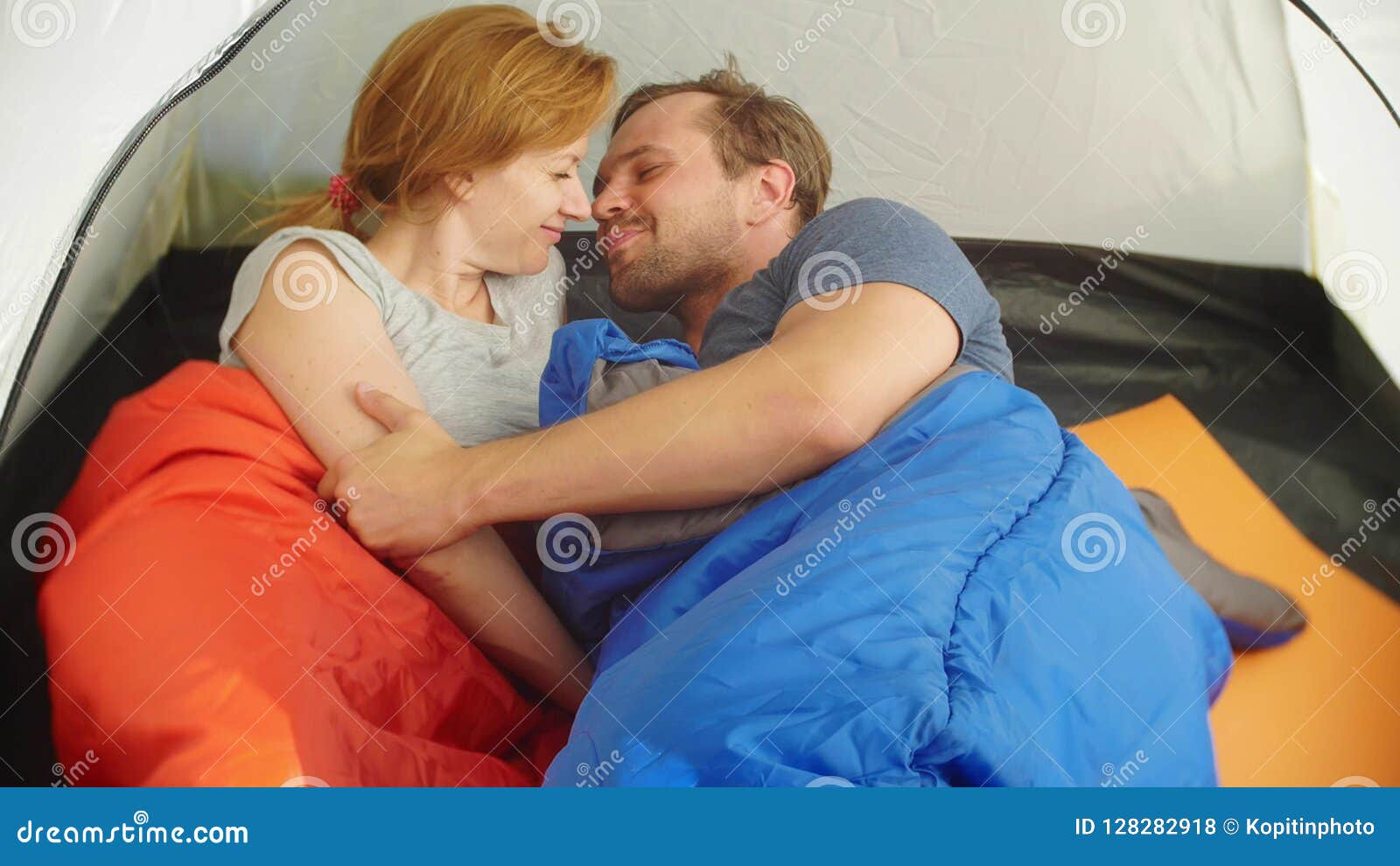 Closeup. a Cute Couple Hugging Inside a Tent Lying in Sleeping ...