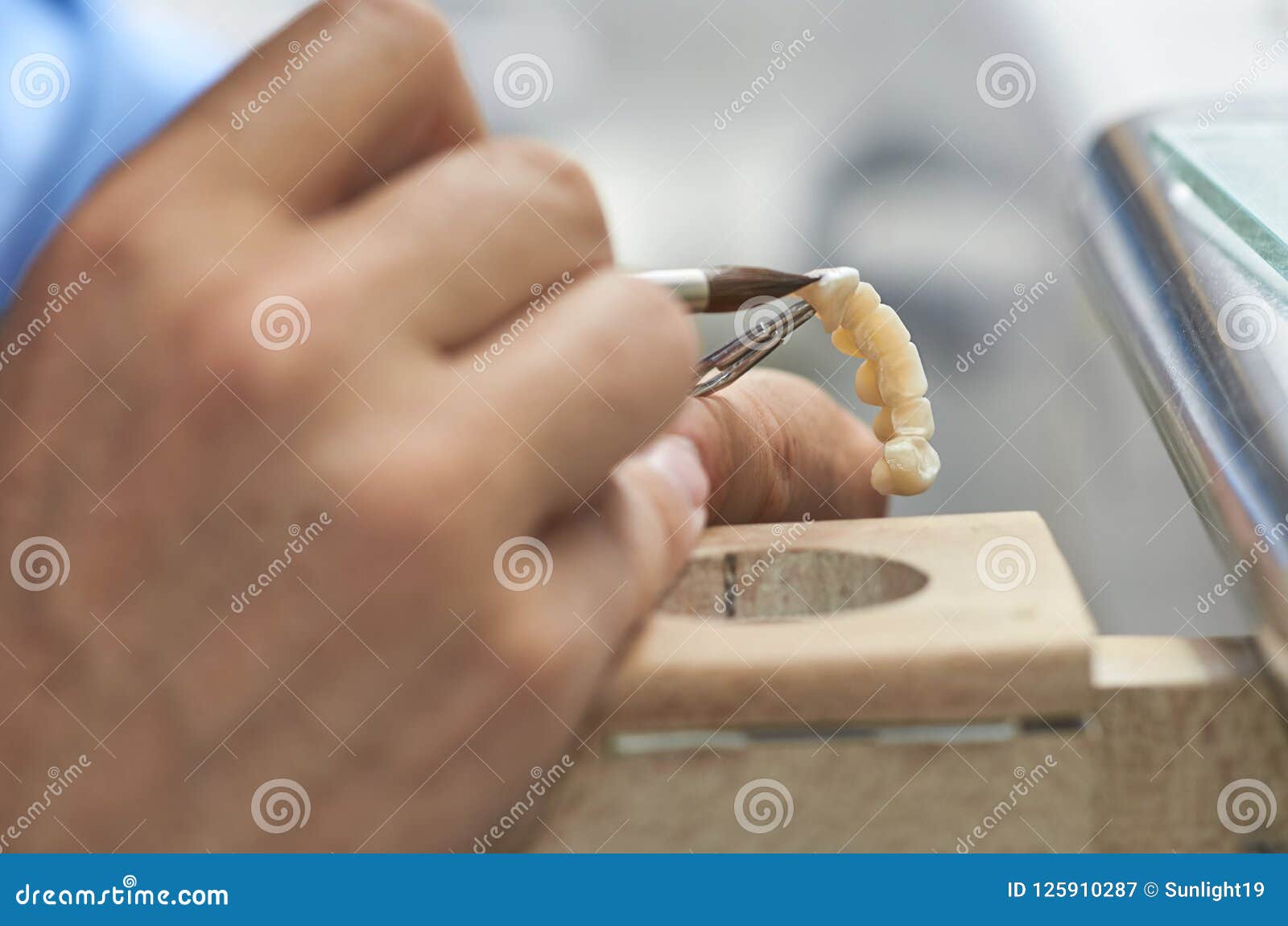 Closeup of Dental Technician Putting Ceramic To Dental Implants Stock