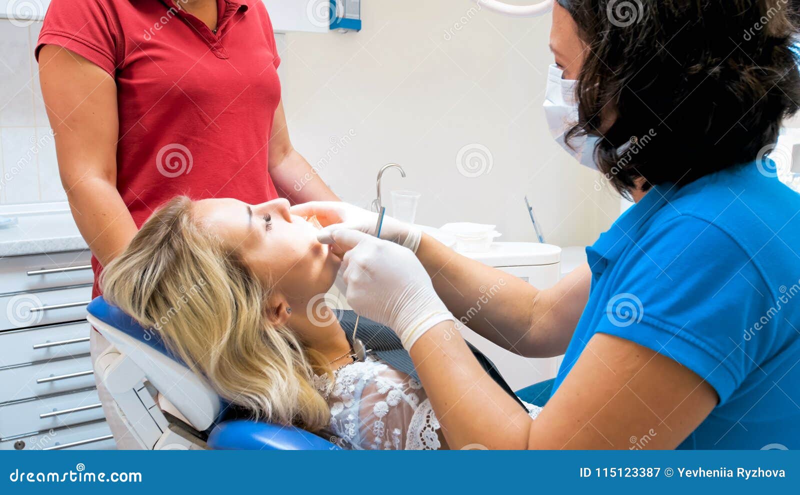 Closeup Image of Dentist Inserting Special Mouth Widener Stock Image